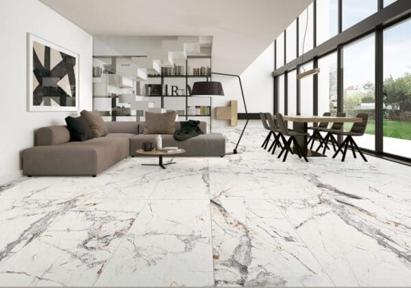 a living room with a sofa, table, and marble flooring