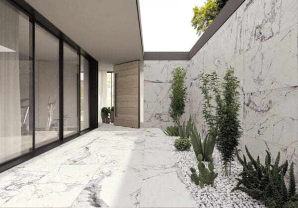 a garden area with marble flooring and plants