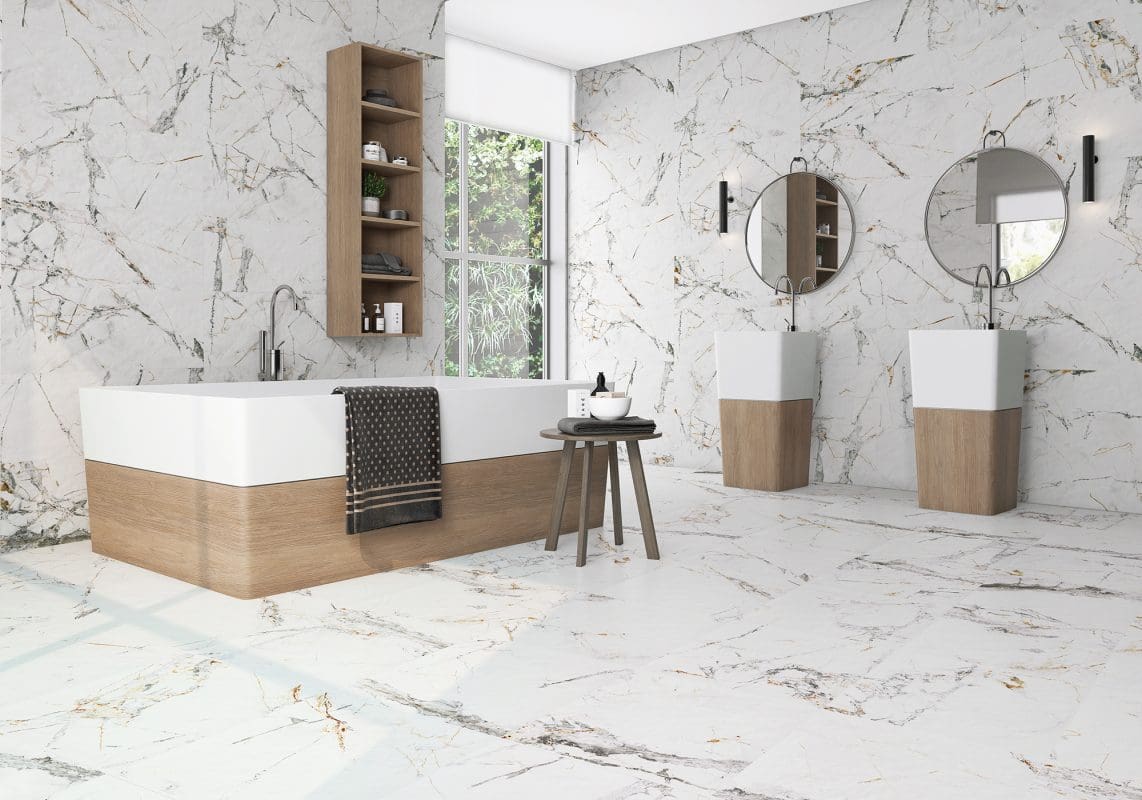 A white bathroom with marble floors and walls.