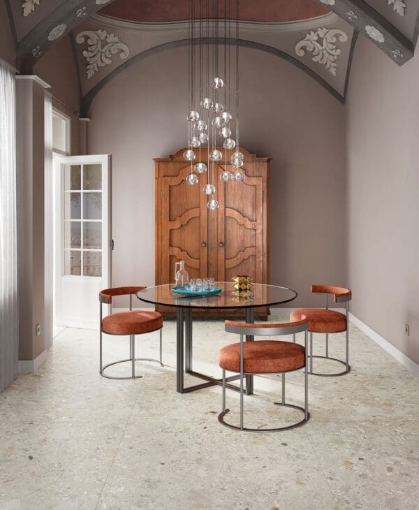 a round dining table with three chairs