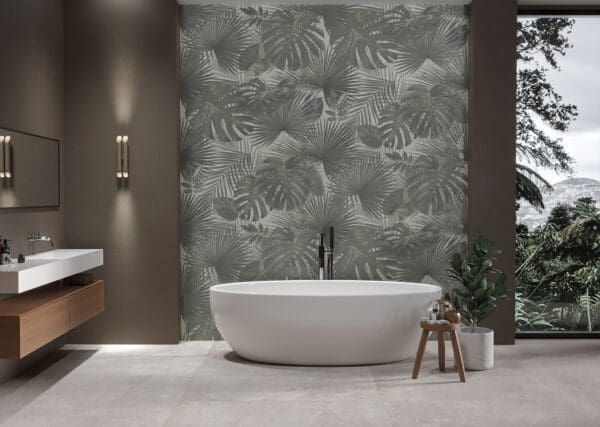 A modern bathroom with a bathtub and a palm tree wallpaper.