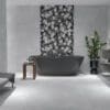 a stylish bathroom with a grey bathtub and two mirrors