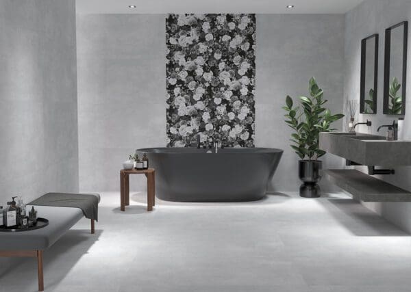 a stylish bathroom with a grey bathtub and two mirrors