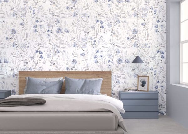 A bedroom with blue and white floral wallpaper.