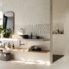 a bathroom with towels, mirror, and other items